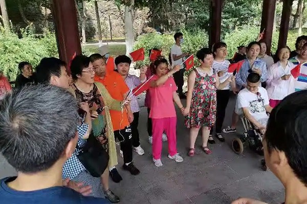 Disabled and Christian families put on performance in a corridor in Xuanwu Lake Park in Nanjing, Jiangsu, on June 12, 2021.