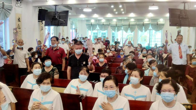 Each male believer received two flowers during Sunday services held in Guangxi Beihai Church on June 20, 2021.