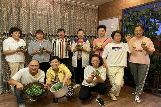 Members from Jida Church in Kunming, Yunnan, took a group picture with rice dumplines in hands on June 13, 2021.