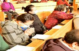 Believers listen to a sermon carefully, with one praying.