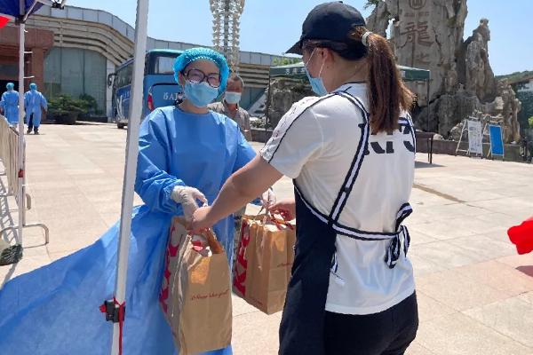 A staff worker of the Amity Foundation provided meals to front-line medical workers at a nucleic acid testing site starting from July 21, 2021.