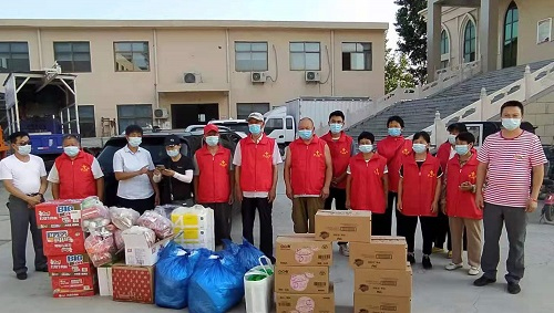 The volunteers were pictured with the relief materials for the Xinxiang City in Henan which was flooded by torrential rainstorms on July 21, 2021.