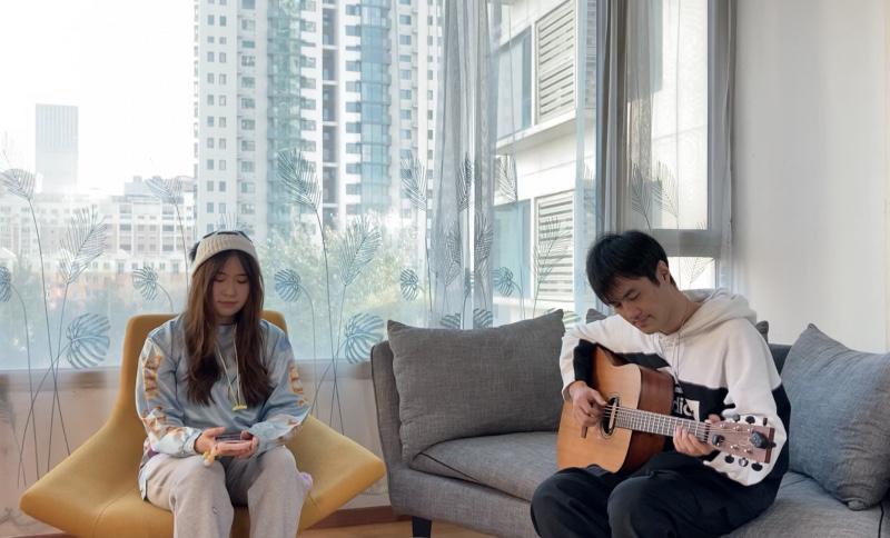 Female believer Lin Ruiqi and a boy playing guitar