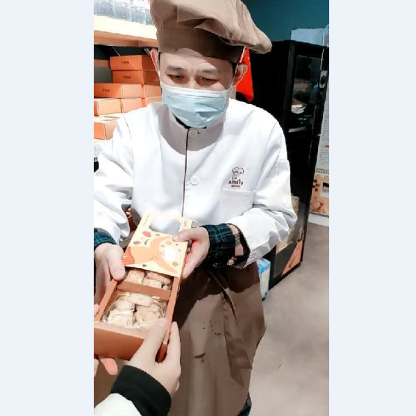 Fufu, a worker in the Amity Bakery with mental disabilities, introduced the freshly baked cookies in Nanjing, Jiangsu Province, on December 3, 2021.
