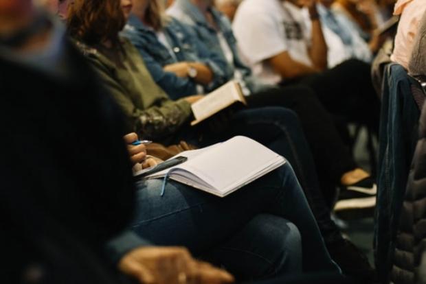 People listen to a sermon in a church service. 