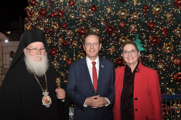 President Isaac Herzog and First Lady Michal Herzog met an Orthodox church leader in front of the Orthodox Church's Christmas tree in Nazareth, Israel on December 14, 2021. 