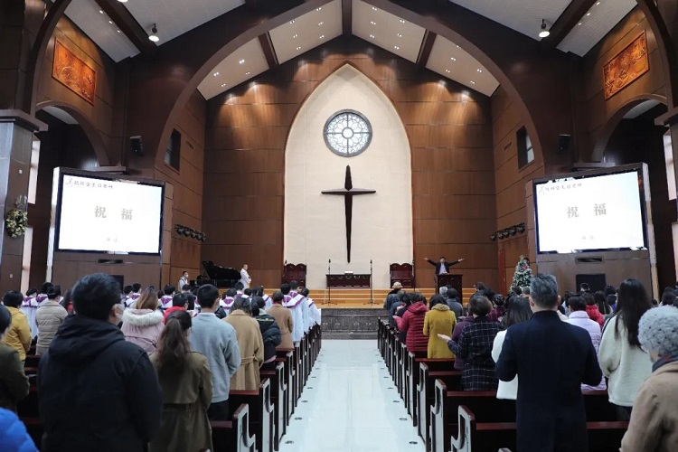 A pastor blessed the congregation after a Christmas worship service in Fujian Theological Seminary in December 2021.
