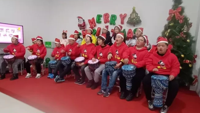 The photo taken in an unknown year shows Kids with Down syndrome playing drums to celebrate Christmas.