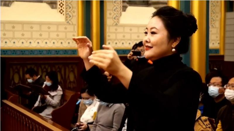 A woman was conducting a program in a Catholic concert called “Chinese Church Music Since the Tang Dynasty” held in the Church of the Savior in Beijing on October 16, 2021.