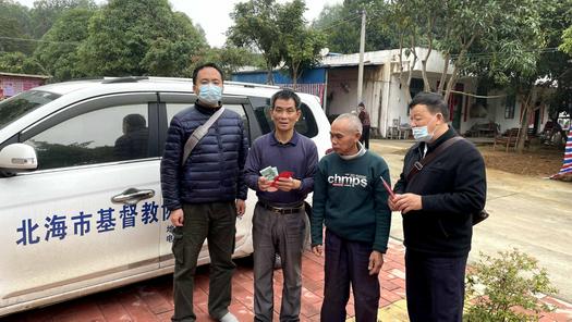 Rev. Zhang Zhongye (the first from right) was pictured with a leprosy patient in Jiaolongtang Village, Hepu County, Beihai, Guangxi, on January 26, 2022.