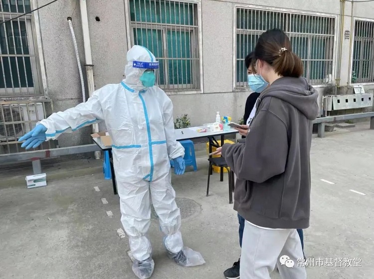 A COVID-19 worker showed two citizens to access nucleic acid testing in Changzhou, Jiangsu, on March 15, 2022.