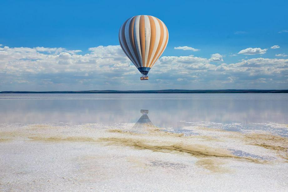 A hot air balloon flying over the sea