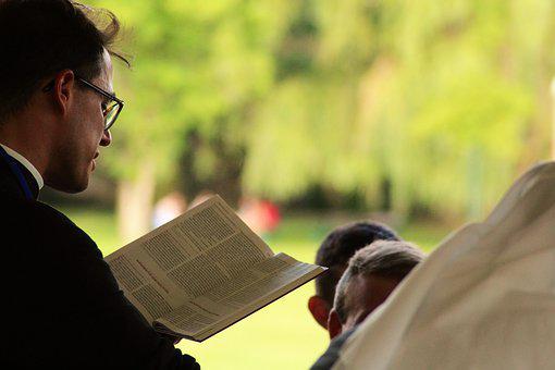 A picture shows a pastor reading the Bible.