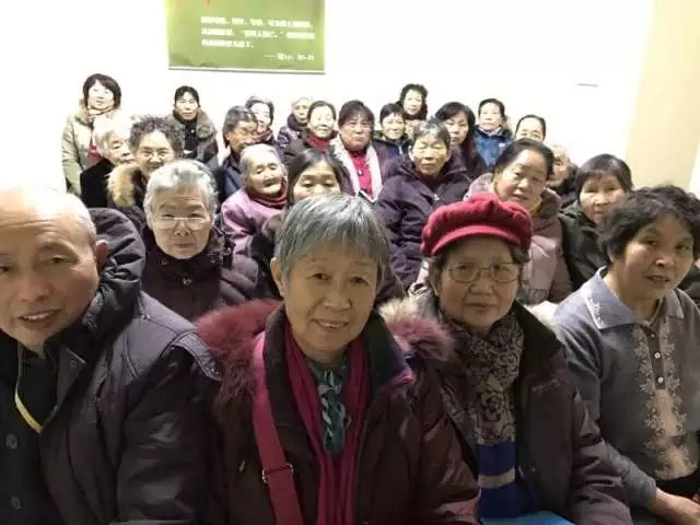 A picture shows many senior believers sitting inside a church.