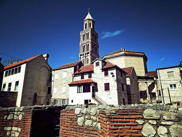  A picture shows a tall church towering over some old buildings.