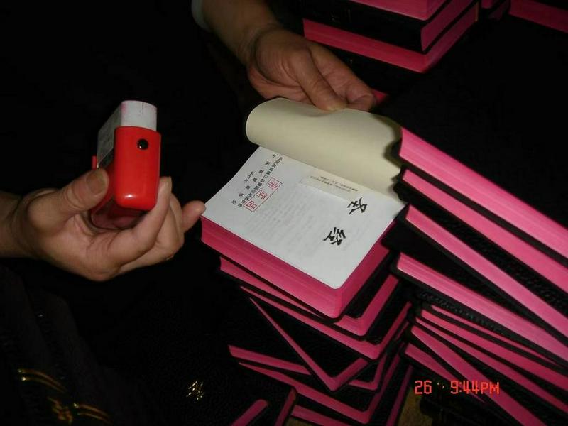 A picture shows a believers stamping the words "Not for sale" in the Bibles after the Sichuan Earthquake occurred on May 12, 2008.