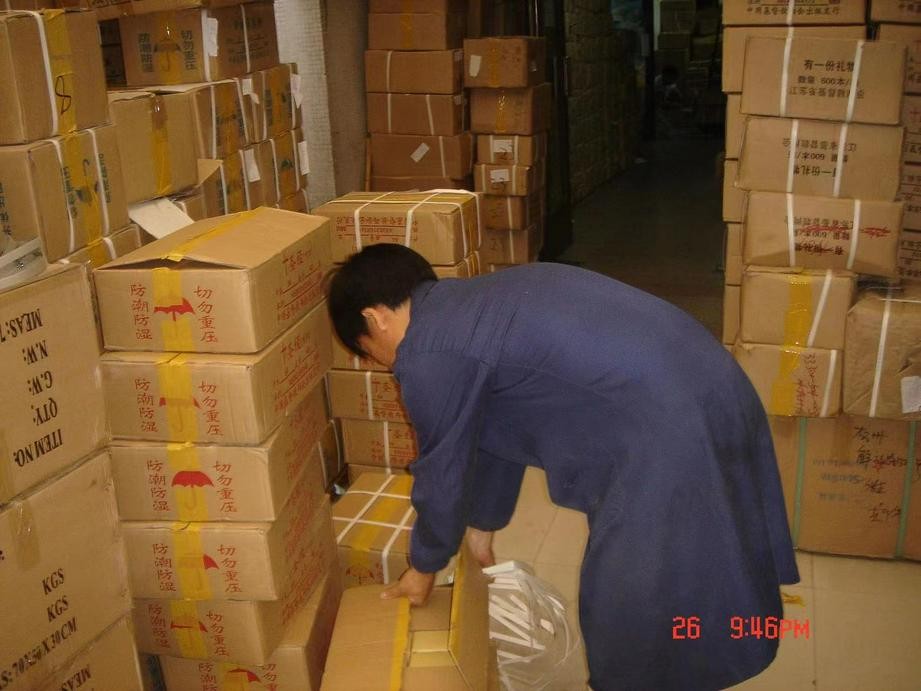 A picture shows a man unpacking relief supplies which were for the Sichuan Earthquake that occurred on May 12, 2008.