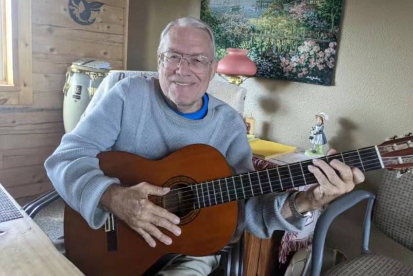 John Carl Schmidt recently played a guitar at his home.