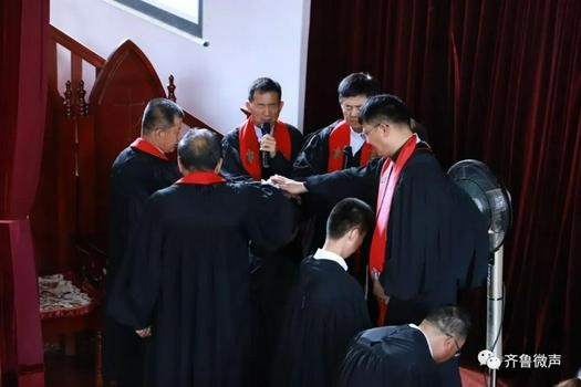 The pastorate laid their hands on newly-ordained pastors or elders at Shuangjie Church in Liaocheng, Shandong, on June 25, 2022.