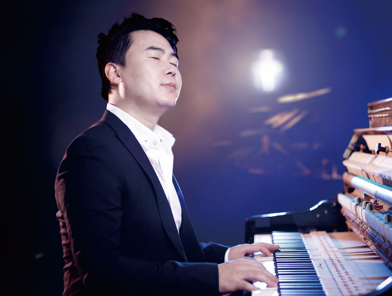 A picture shows a man playing piano.