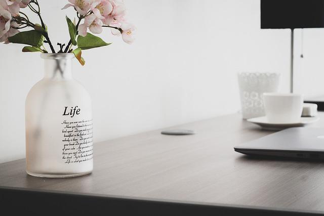 A picture shows a vase with flowers on a table.