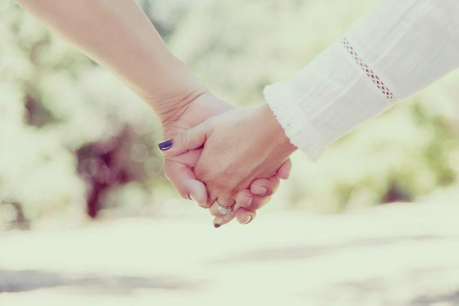 A picture shows a couple holding hands.