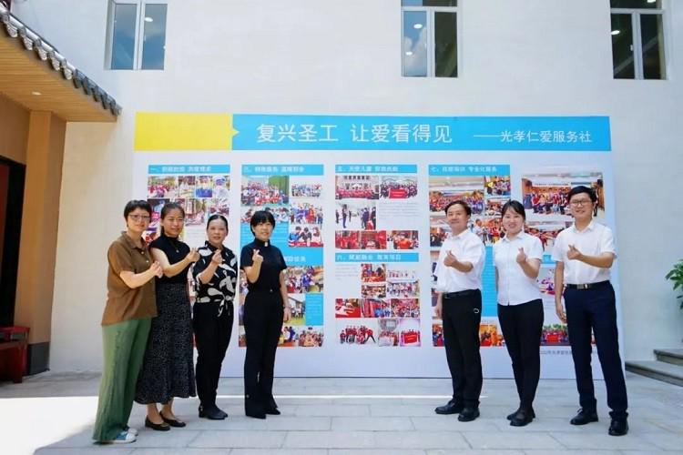 Pastors and members of Guangxiao Church in Guangzhou, Guangdong, took a group picture during a photo exhibition to show its charitable activities on August 7, 2022. 