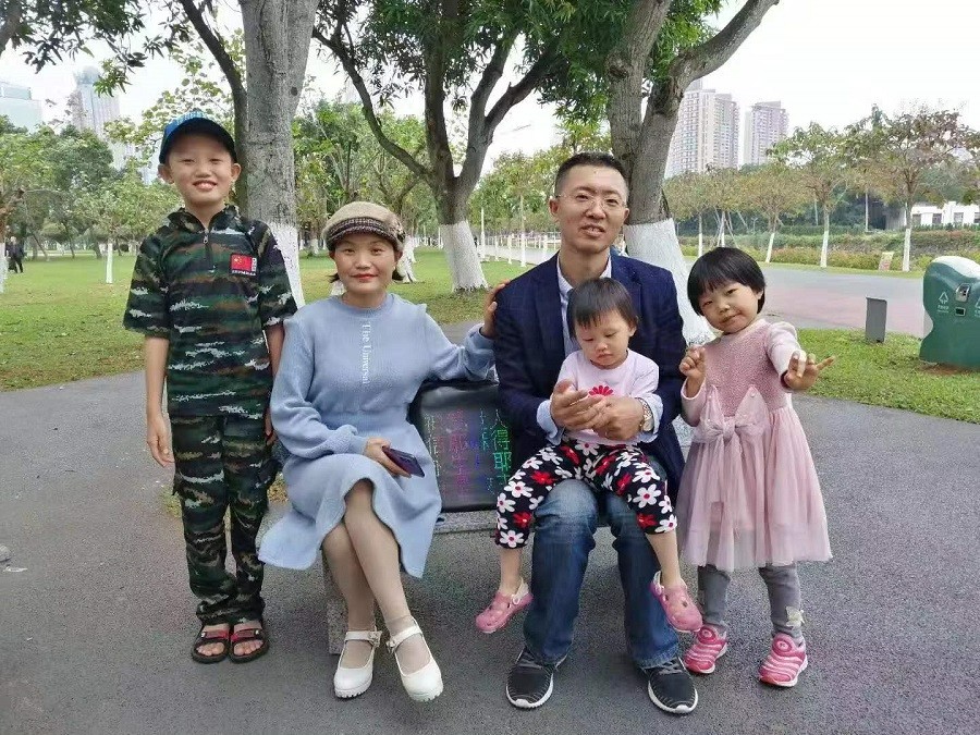 A picture shows a female Christian named Lu Yun pictured with her husband and children.
