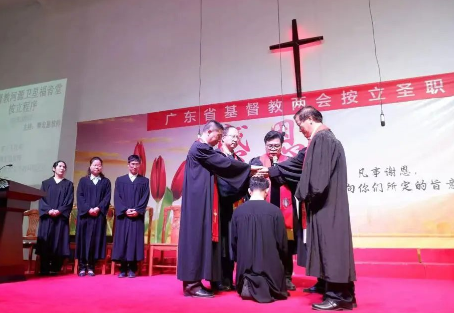 The pastorate put their hands on a male staff member during an ordination service held in Gospel Church, Weixing District, Heyuan City, Guangdong Province, on November 5, 2022.