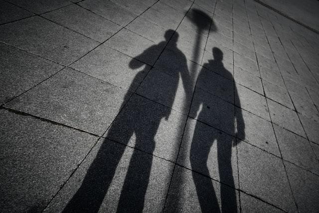 A picture shows a shadow of two men hand in hand.
