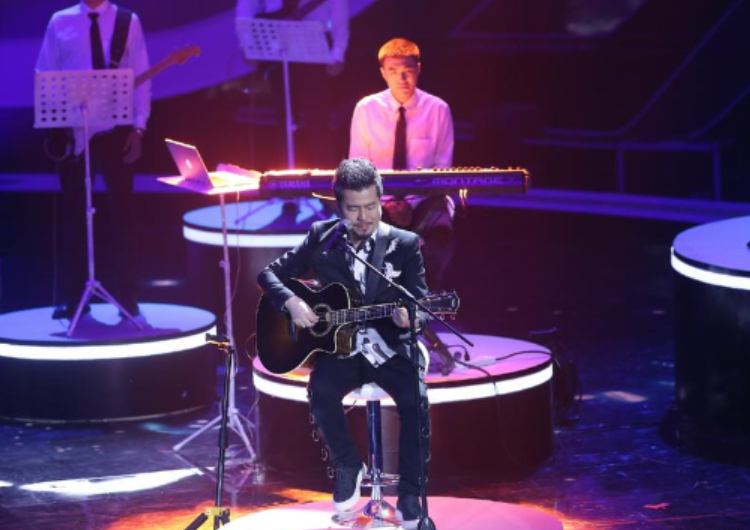 A picture shows Vintz Huang, a Taiwanese artist, playing a guitar on the stage at an unknown date.
