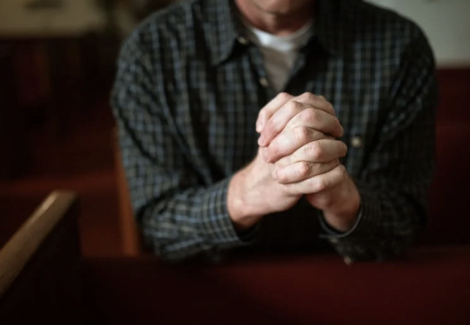 A picture shows a man praying.