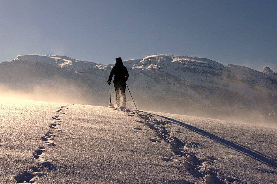 A picture shows a man walking on the snow