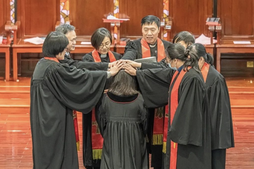 The pastorate of Shanghai Christian Council laid hands on a female staff member in Huai'en Church, Jing'an District, Shanghai, on Dec. 2, 2022.