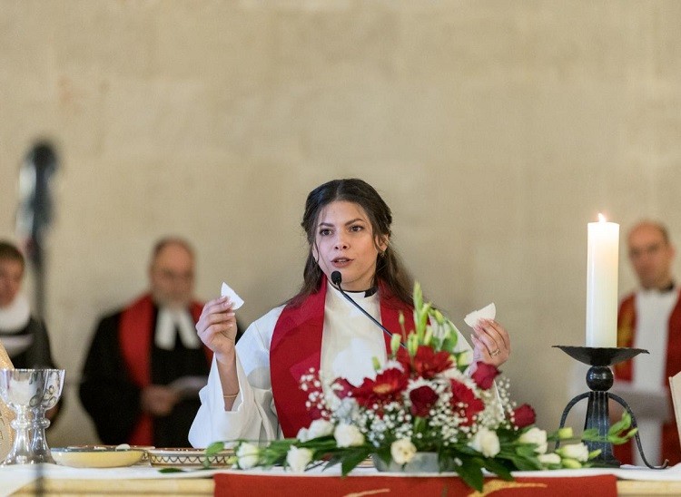 Rev. Sally Azar, ordained minutes earlier as pastor in the Evangelical Lutheran Church in Jordan and the Holy Land, presides over Holy Communion at the conclusion of her ordination service at the Lutheran Church of the Redeemer in Jerusalem, Palestine, on  22 January 2023.  