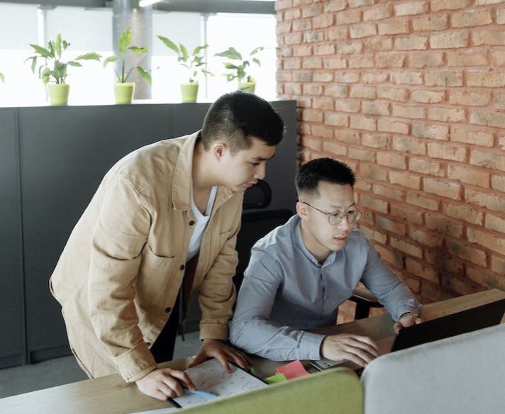 A picture shows two men in their workplace.