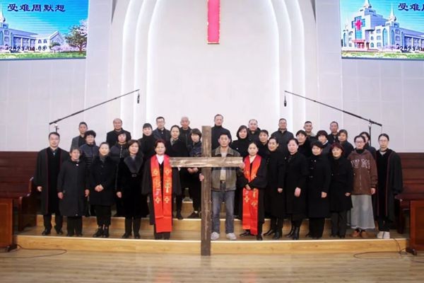 Pastors and members of Huai'an Church in Jiangsu took a group picture with a wooden cross on April 7, Good Friday, 2023.