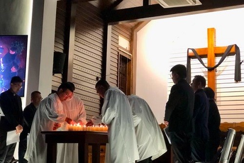 Church staff of Sicheng Church in Hangzhou, Zhejiang, lit a candle cross during a worship service on April 7, Good Friday, 2023.