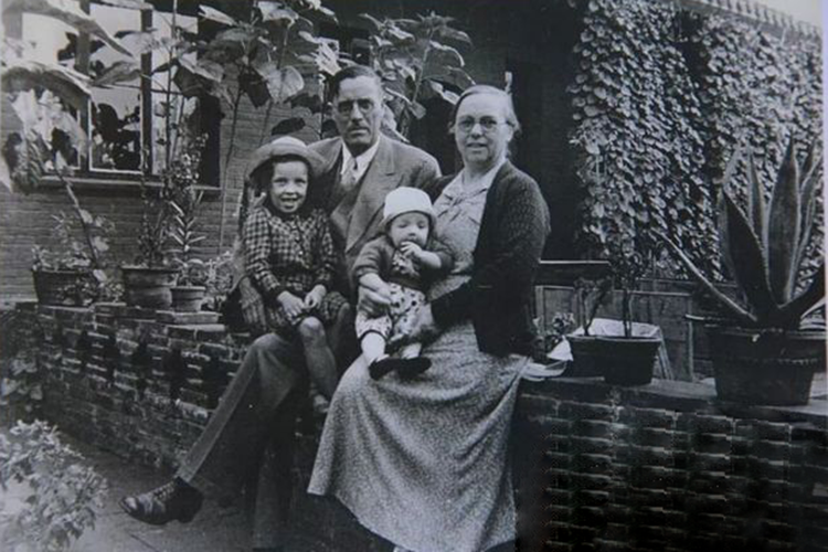 A historical picture of Hannah Wang with her parents and brother