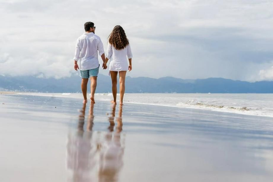 A picture of one couple walking on the beach